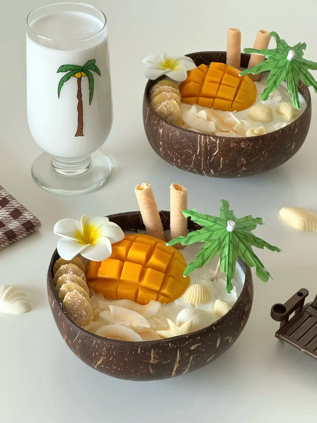 Mango-filled coconut bowls on a bright table